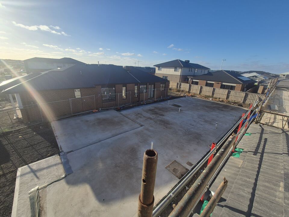 Finished concrete slab at Jagged Circuit with neighbouring homes behind