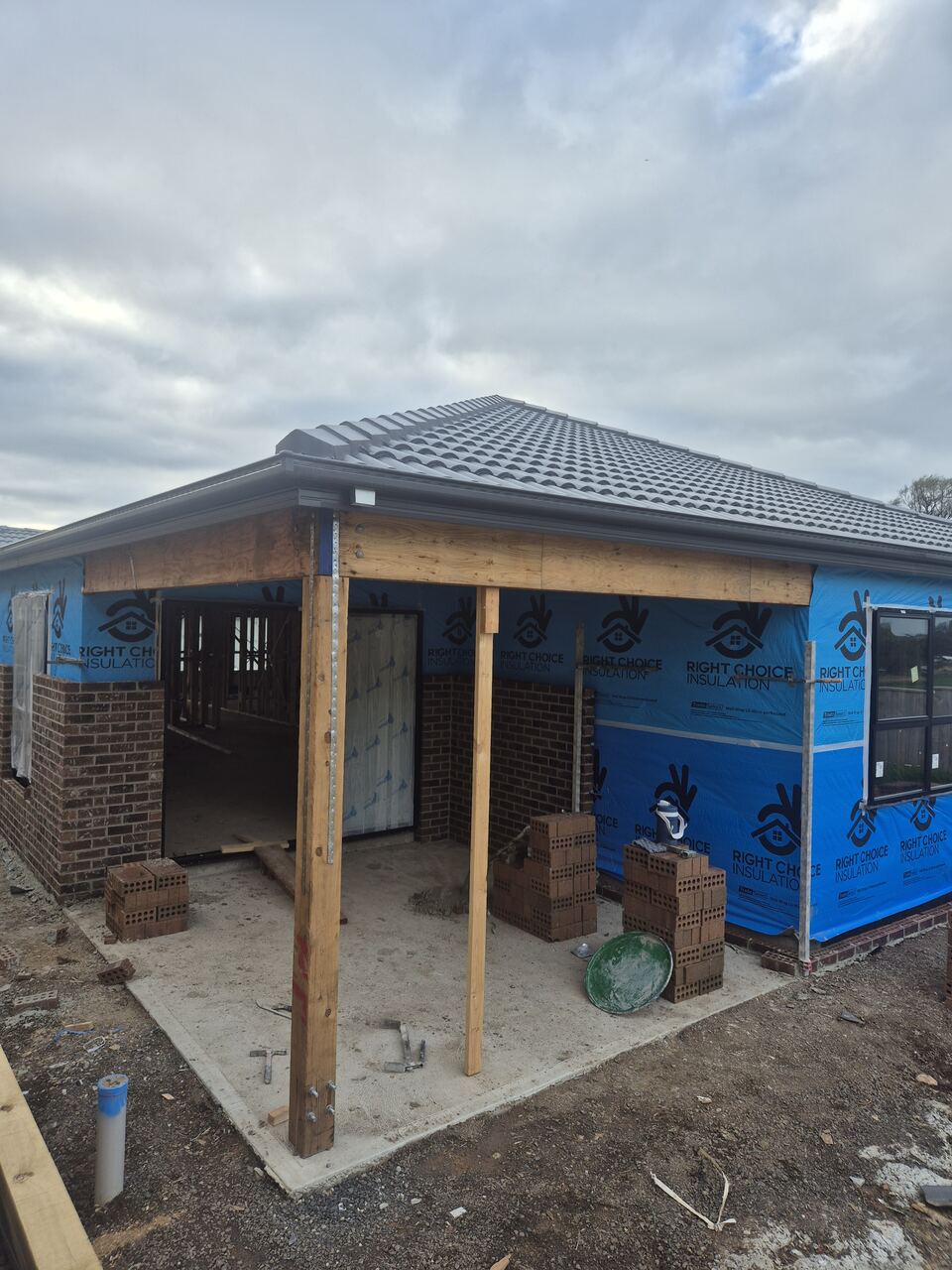 Ladhams Way with the roof tiled and brickwork going up around the porch