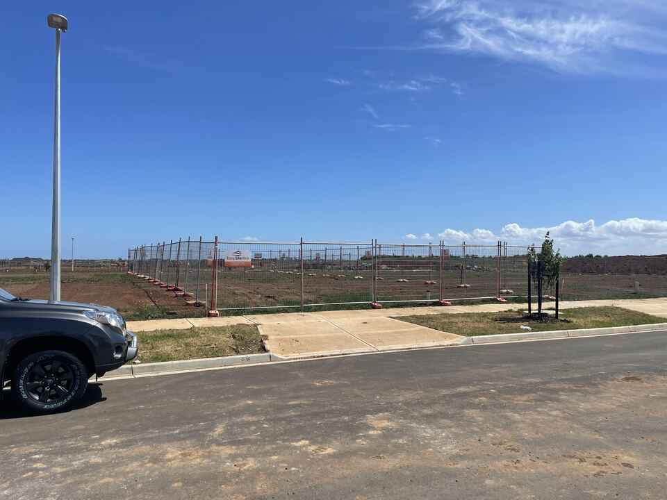The empty, fenced block on a new estate before work started on Lucania Crescent