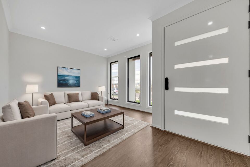 Front lounge at Lucania Crescent next to a tall front door with frosted glass strips (furniture digitally added)