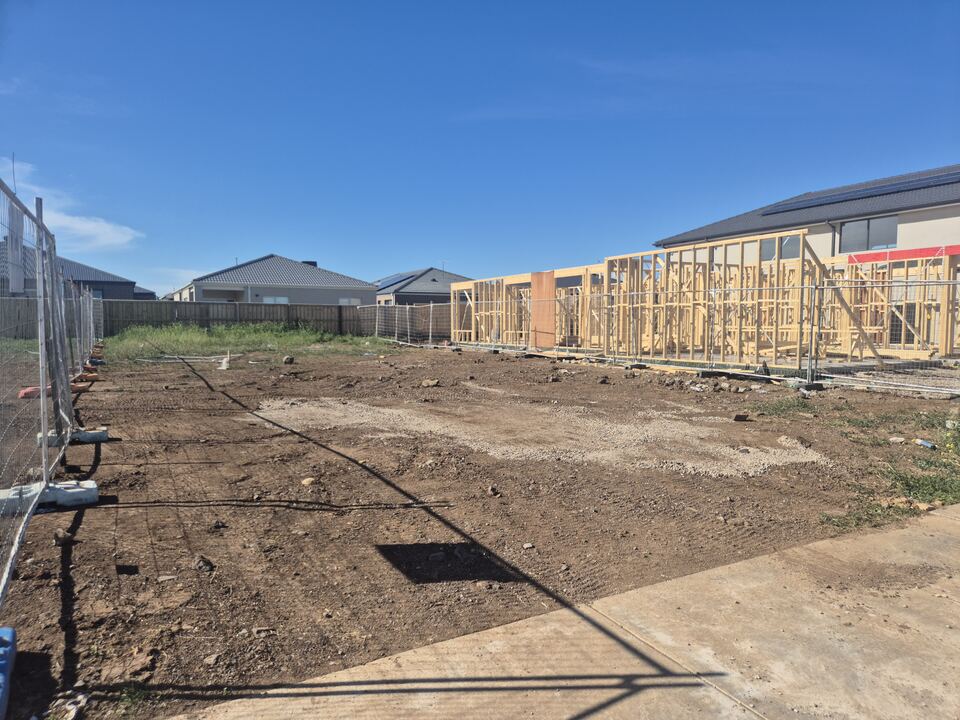 The Verday Boulevard block after site set-out, with neighbouring house frames behind
